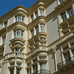 An ornate building with MCPGZ0003 and balconies.