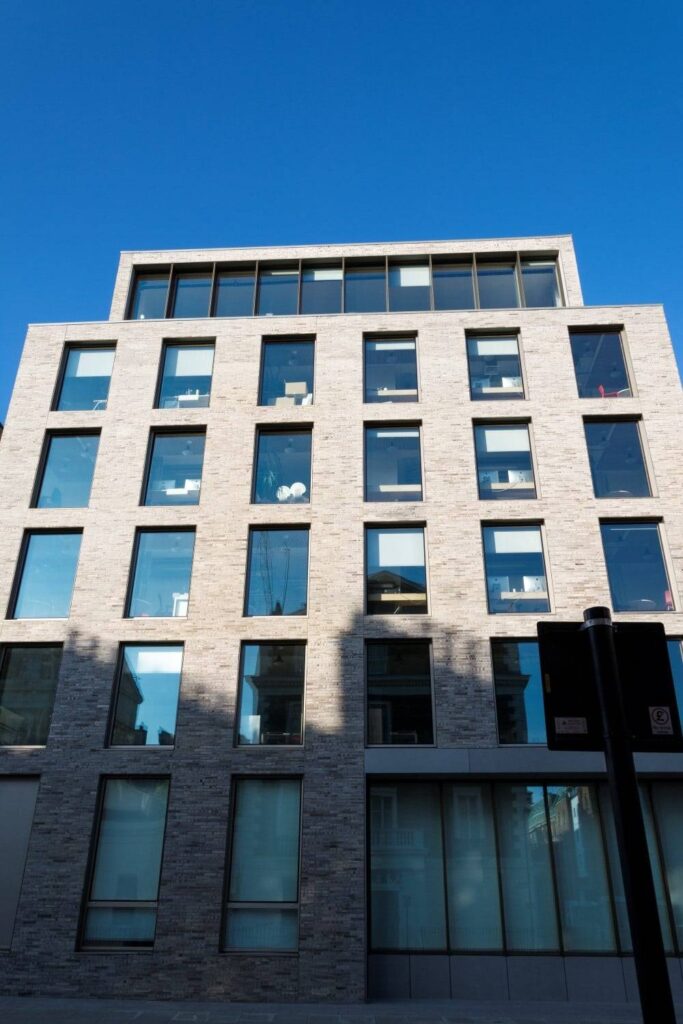 A building with many windows and a blue sky.