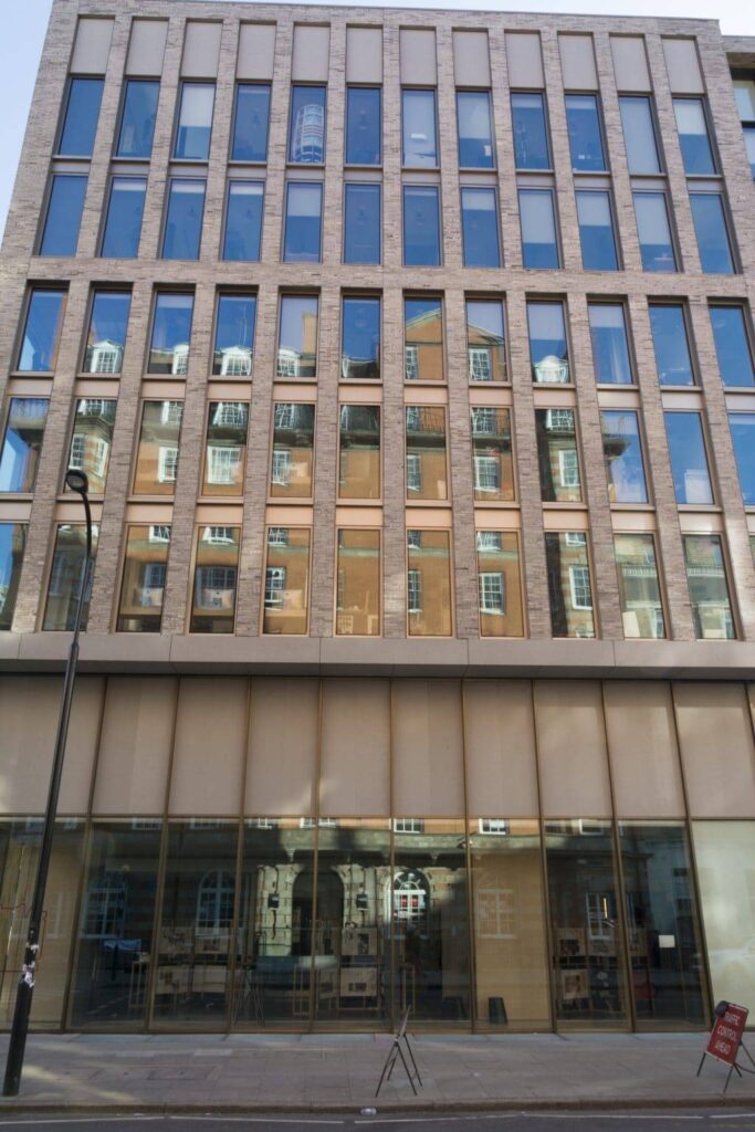 The front of a large building with glass windows.