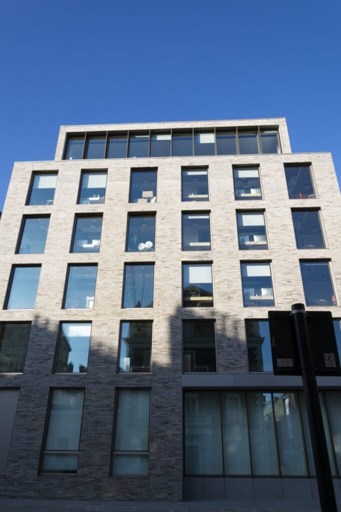 A building with many windows and a blue sky.