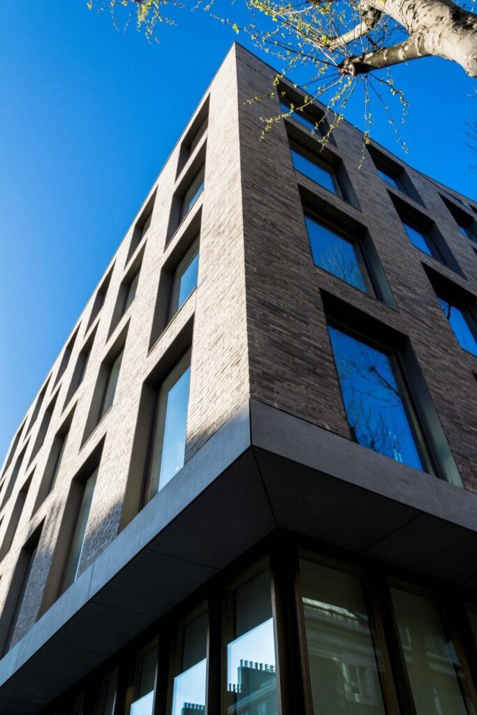 A building with many windows and a blue sky.