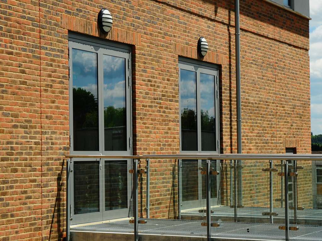A red brick building with a MCP1098 railing.