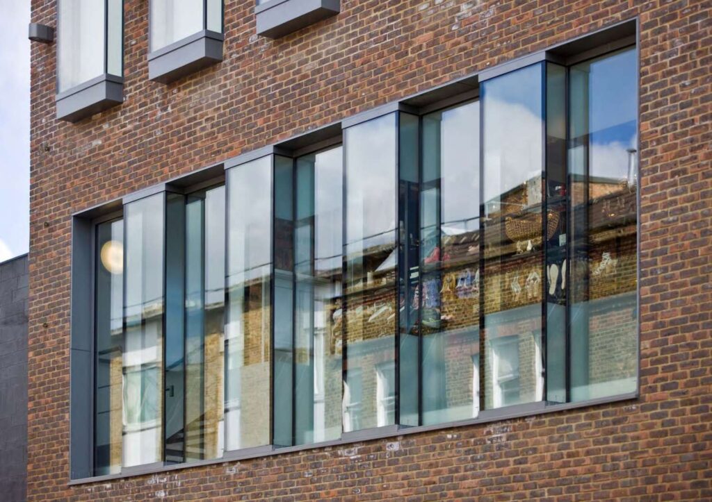 A red MCP1117 building with glass windows.