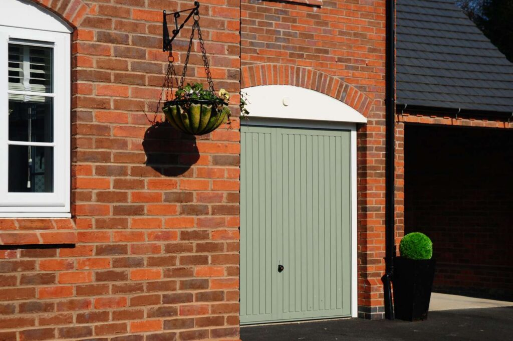 A red brick house with an MCP1119 garage door.