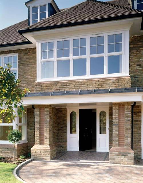 A house with large windows and a MCPB180 driveway.