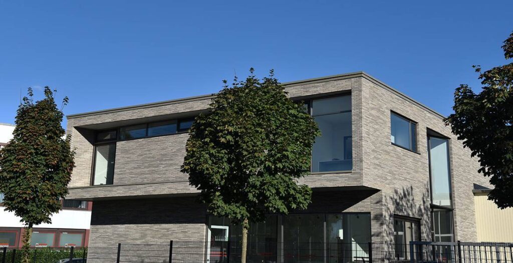 A modern building with a MCPN034 in front of it.