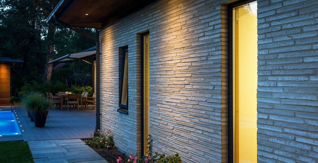 A house with MCPN037 and a stone wall.
