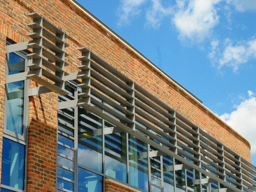 A building with MCP1099 slats and a blue sky.