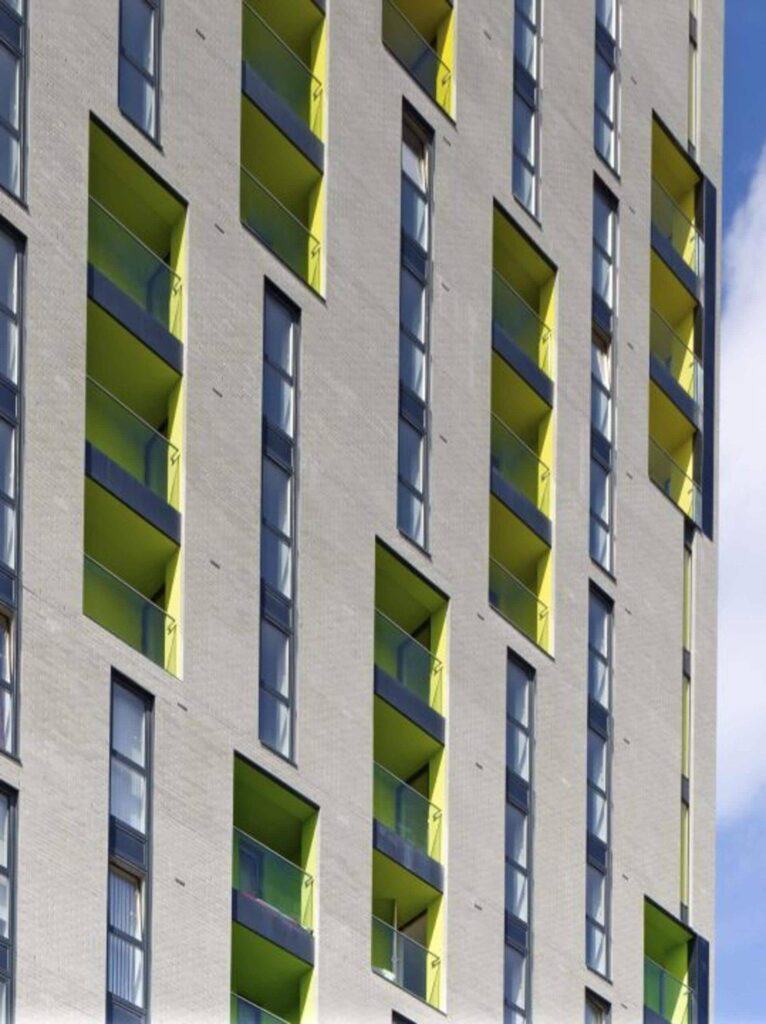An MCP2317 building with green windows and balconies.
