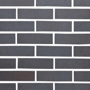 A close up of a brick wall in a dark color.