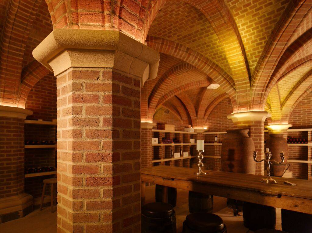 A MCPE056 cellar in a brick building with arches.