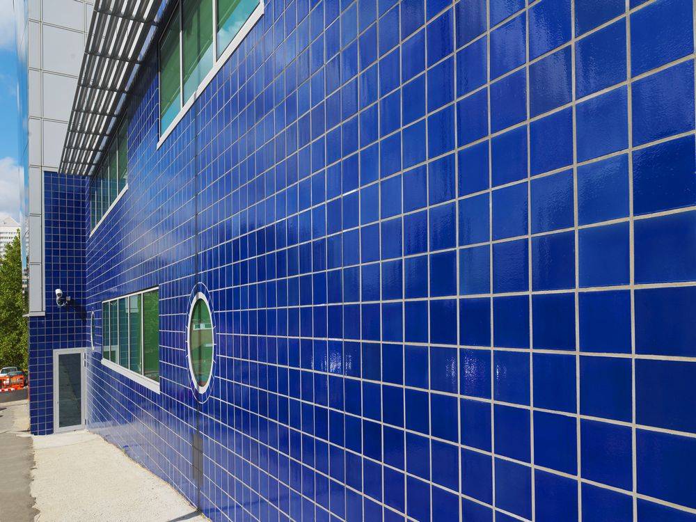 A building with blue tiles on the side of it.