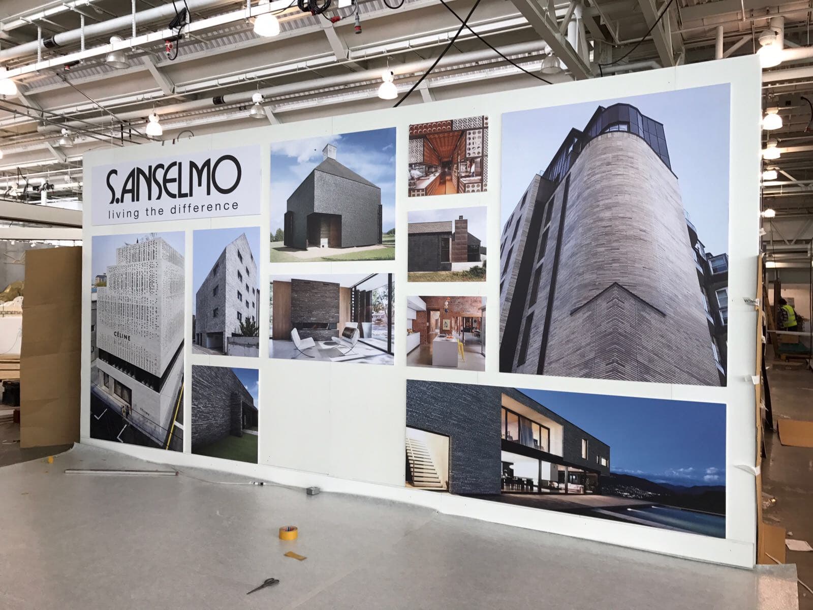 A display of pictures of buildings in a room.