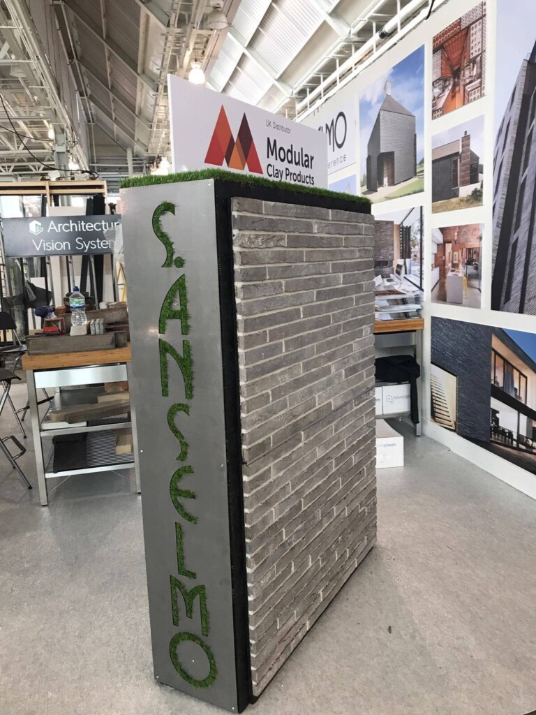 A stand with a sign that says saneloo.