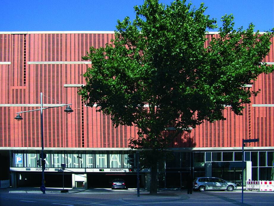 A MCPH041 building with a tree in front of it.