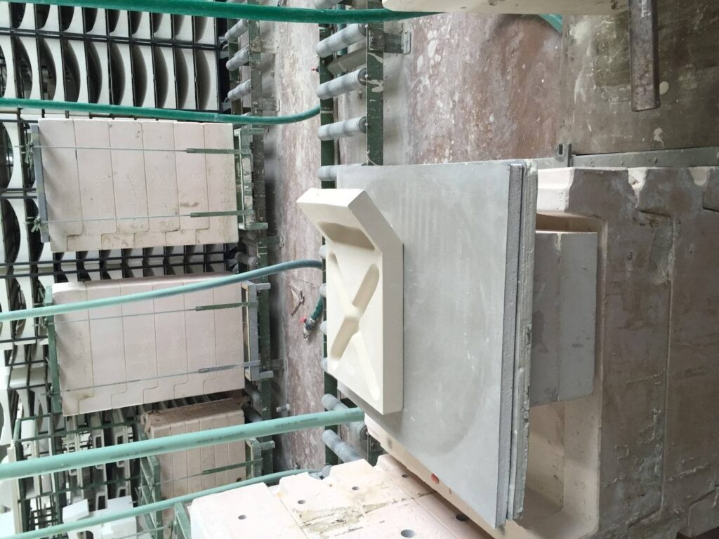 A machine is being used to make a concrete block.