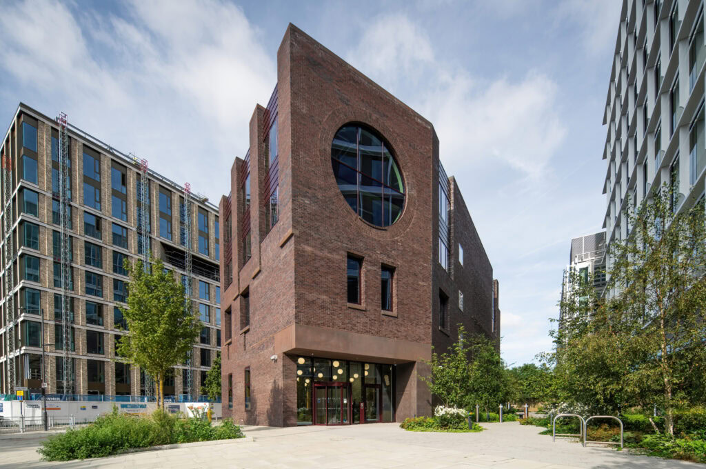 Modern brick building with large circular windows.