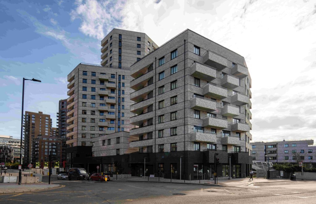 A street scene with modern apartment buildings featuring MCPV175 and a mix of brick and glass