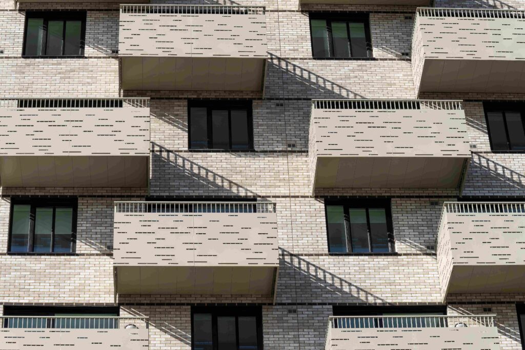 A residential building's facade showing repeating patterns of MCPV175, windows, and balconies.